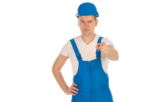 serious young man builder in blue uniform - Fotoğraf, Görsel