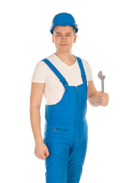 builder in blue uniform with tools in hand - Foto, Imagen