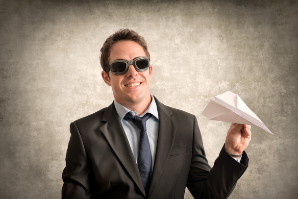 Young businessman with paper plane - Fotó, kép