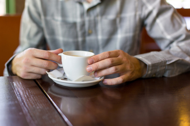 a man in a cafe drinking tea at the table - Fotoğraf, Görsel