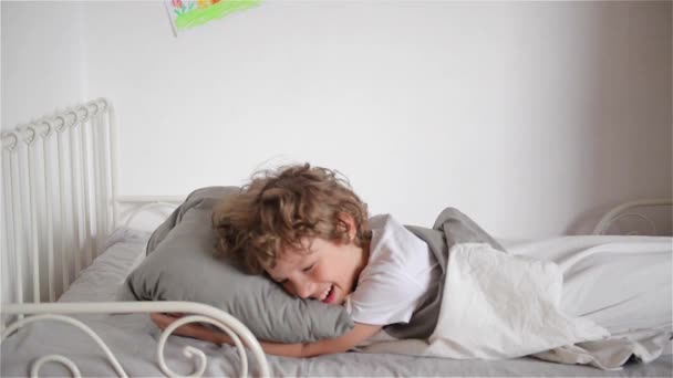 Overslept boy does not want to wake up, child falls out of bed - Footage, Video