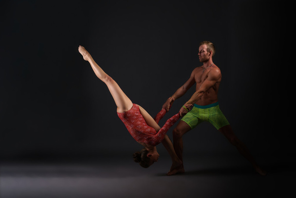 Couple of gymnasts performing trick at camera - Fotoğraf, Görsel