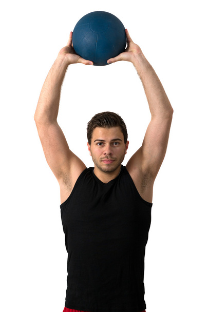 Attractive brunette man working out with a medicine ball - 写真・画像