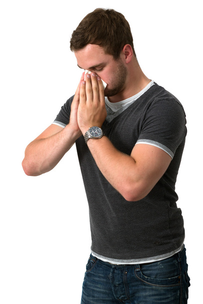 mladý muž foukání nosem - Fotografie, Obrázek