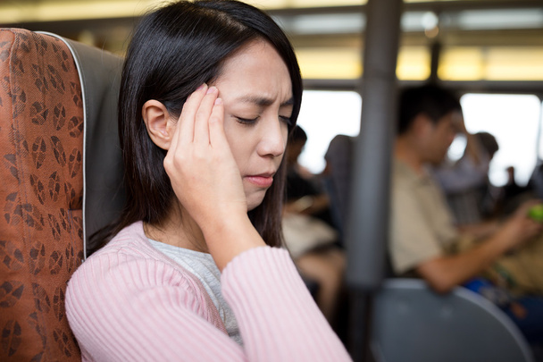 woman suffering from headache on the ferry - Foto, Imagen