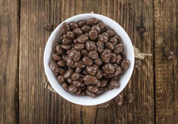 Chocolate Raisins on  wooden background - Zdjęcie, obraz