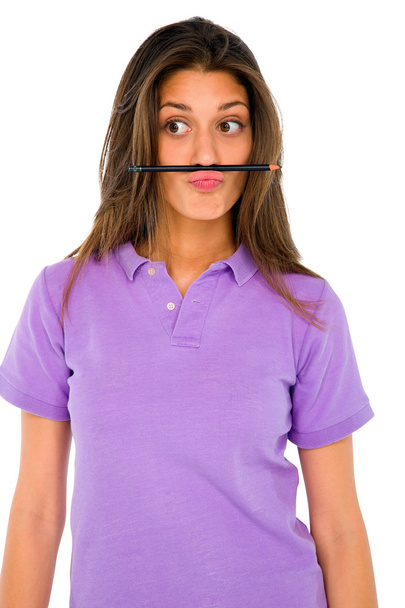 Teenage girl balancing pencil on her lip - Zdjęcie, obraz