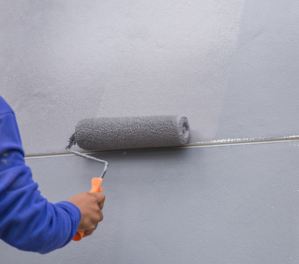painting a wall with painting roller - Photo, Image