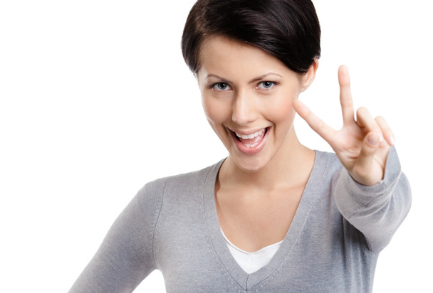 Smiley woman shows victory sign - Fotografie, Obrázek