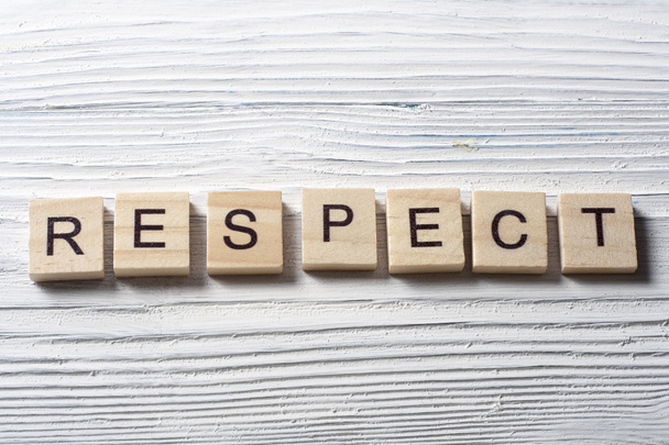 RESPECT word written on wood block ta wooden background - Foto, Imagem