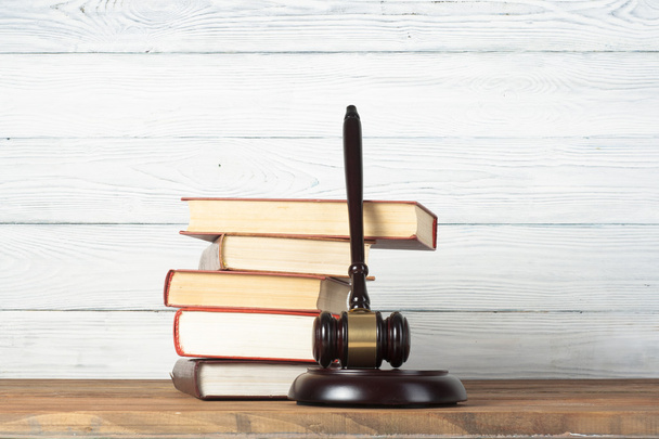 Law concept - Book with wooden judges gavel on table in a courtroom or enforcement office. - Photo, image