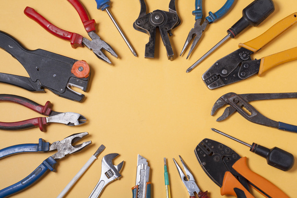 Set of electrical tool on wooden background. Accessories for engineering work, energy concept. - 写真・画像