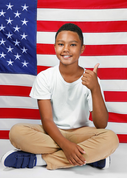Cute boy on American flag - Foto, imagen
