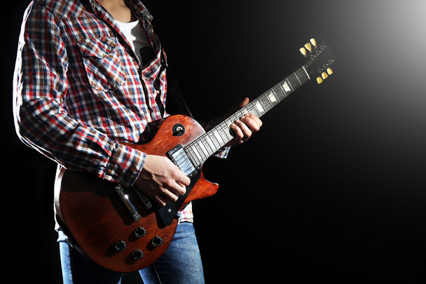 Young man playing electric guitar  - Фото, зображення