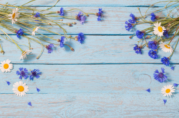 flowers over blue wooden background - Φωτογραφία, εικόνα