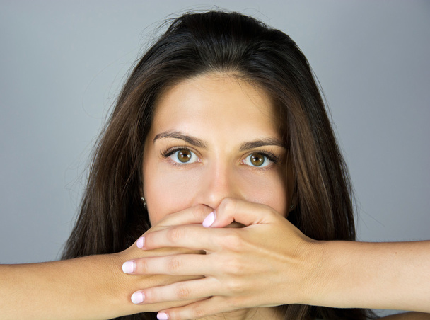 shocked beautiful girl covering her mouth with hands - Foto, Imagen