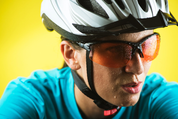 Close-up portrait of female cyclist - Photo, image