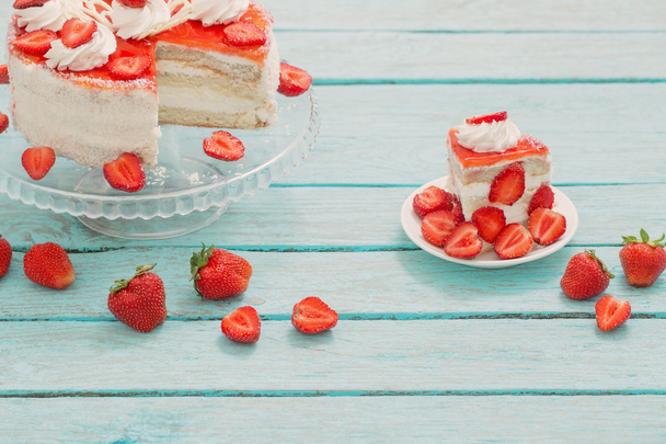 cake with strawberries on blue wooden table - Zdjęcie, obraz