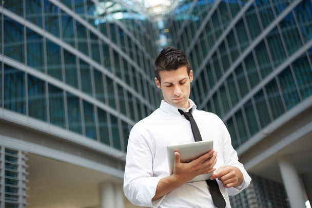businessman using digital tablet outside office building - Φωτογραφία, εικόνα