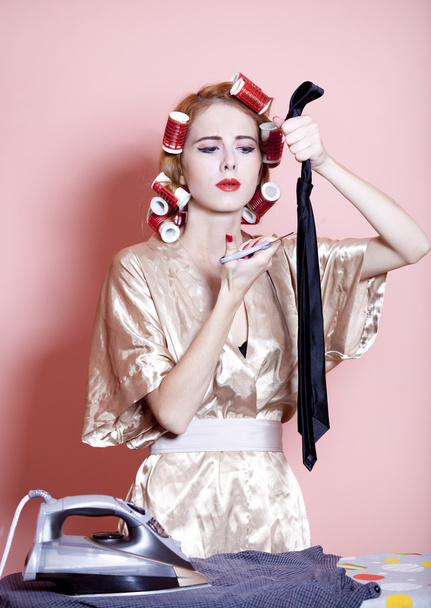Housewife with iron and curler - 写真・画像