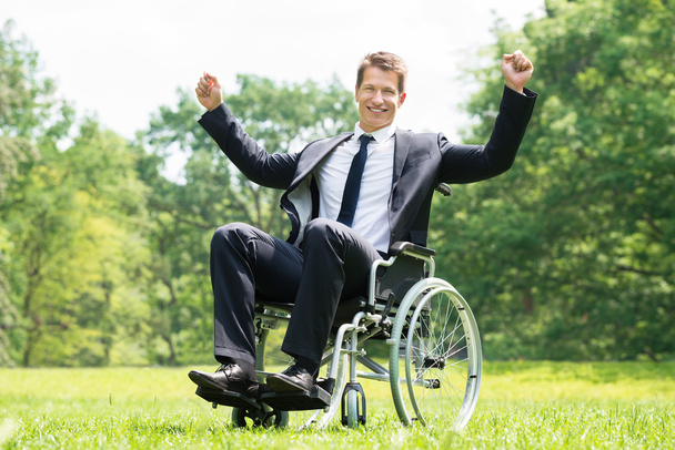 Disabled Man On Wheelchair With Raised Arms - Foto, afbeelding
