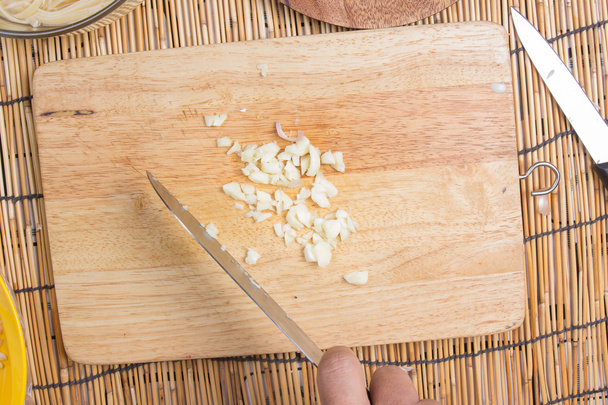 Chef slicing garlic with knife - Photo, Image