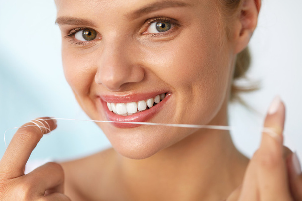 Dental Hygiene. Beautiful Woman Flossing Healthy White Teeth - Fotografie, Obrázek