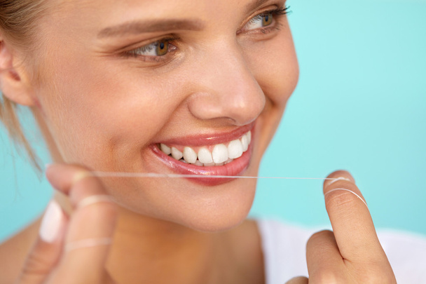 Dental Hygiene. Beautiful Woman Flossing Healthy White Teeth - 写真・画像
