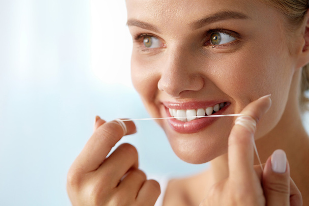 Teeth Care. Beautiful Smiling Woman Flossing Healthy White Teeth - Valokuva, kuva