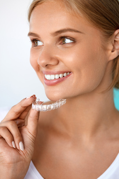 Smiling Woman With Beautiful Smile Using Teeth Whitening Tray - Foto, Imagen