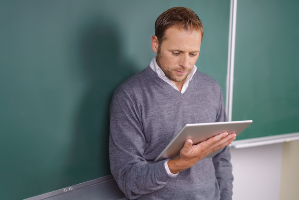Teacher or post graduate student reading a tablet - Foto, Imagen
