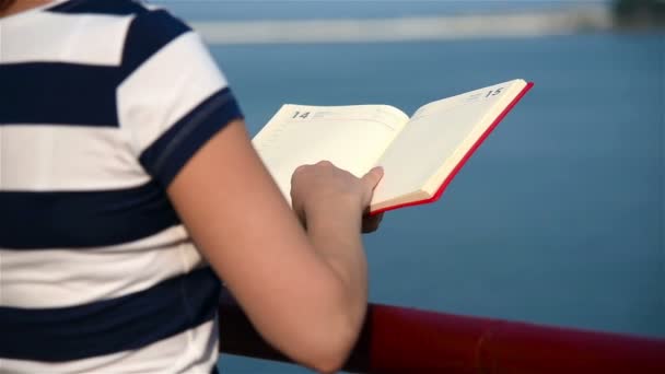 Hipster Girl Hands Hold Red Book. Slow Motion Effect - Materiał filmowy, wideo