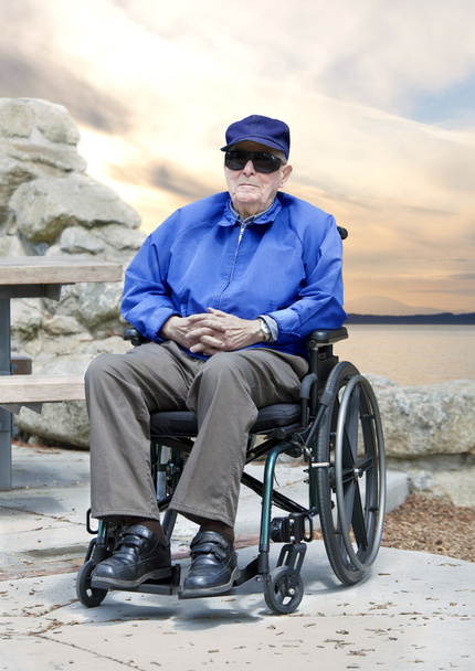 Elderly senior man in wheelchair sitting outside - Фото, зображення