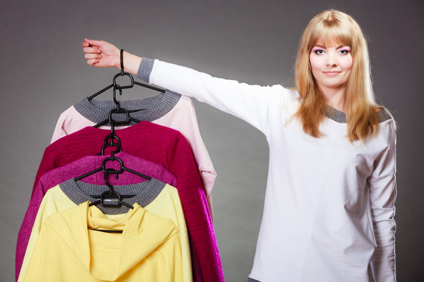 woman customer holding hangers with clothes - Photo, image