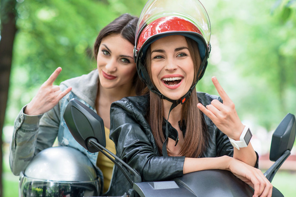 Cheerful young women gesturing on bike - Foto, Imagem