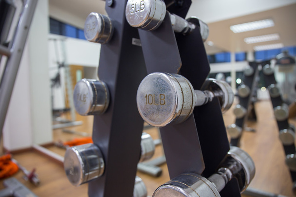 close up group of dumbbells for weight training on rack in workout room - Photo, Image