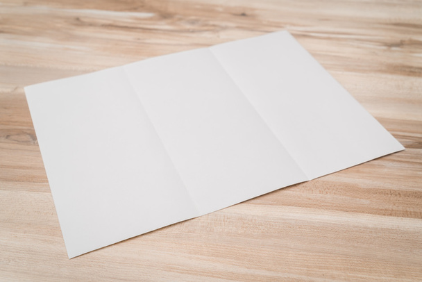 Trifold white template paper on wood texture . - Fotó, kép