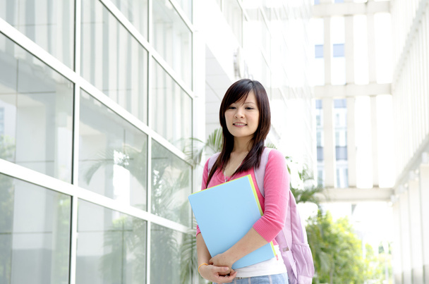College Student standing outside college building - Foto, imagen
