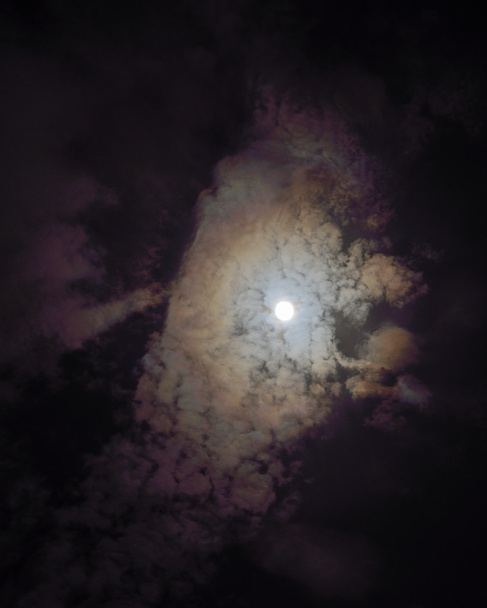 Full moon shining glowing light through the darkness of cloudy n - Photo, Image