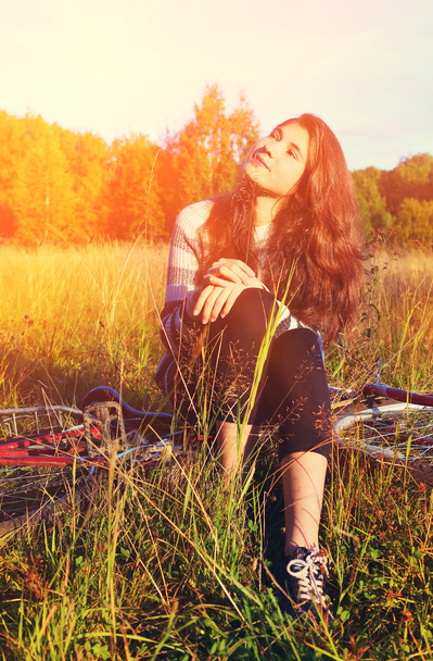 girl on bicycle in the summer sunny field - Photo, image