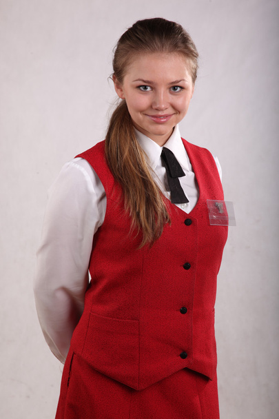 hermosa chica en uniforme y con una insignia
 - Foto, imagen