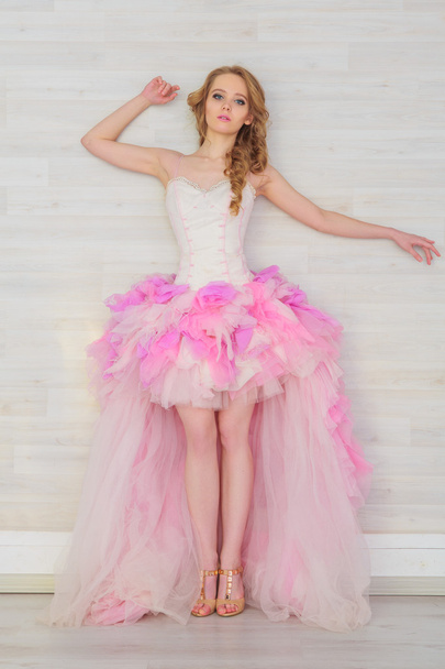 Portrait of a beautiful girl in a pink dress - Foto, Imagen