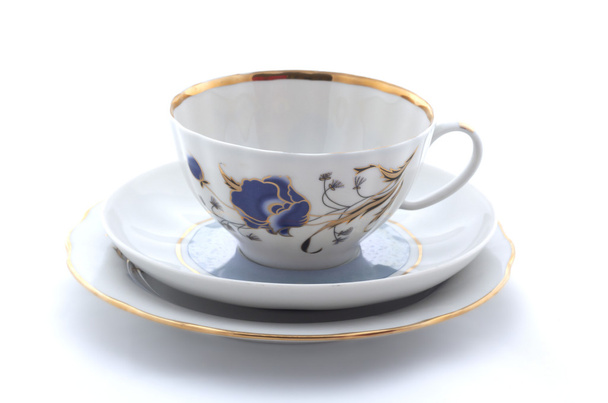 Porcelain cup, plate and saucer on a white background - Photo, Image