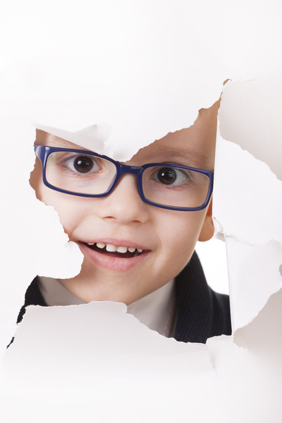 Curious kid looks through a hole in paper - Foto, immagini
