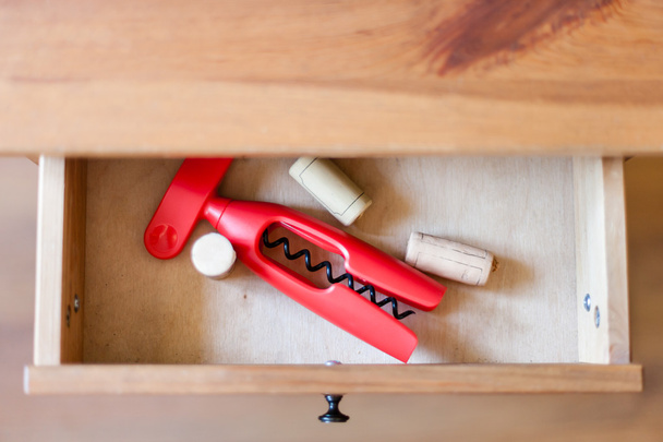 corkscrew and cork from bottles in open drawer - Photo, Image