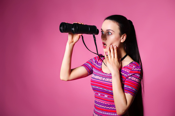 Modern young woman with binoculars in hand. - Foto, Imagem