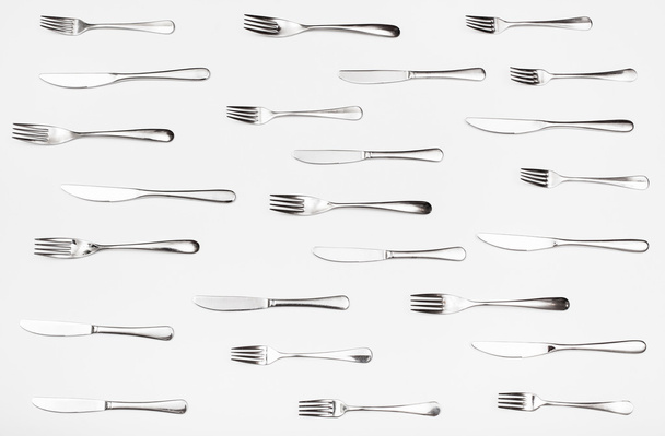 top view of many table knives and forks on white - Φωτογραφία, εικόνα
