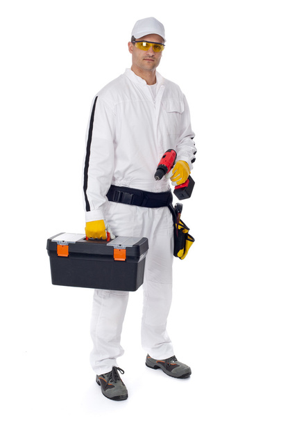Construction worker in white coveralls with a tool box - Foto, imagen