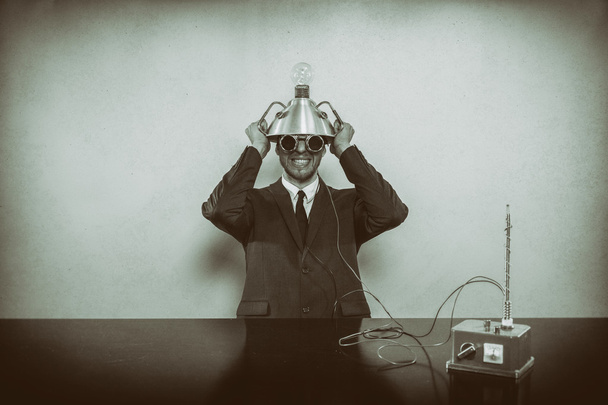 Businessman sitting at office desk with machine - Valokuva, kuva