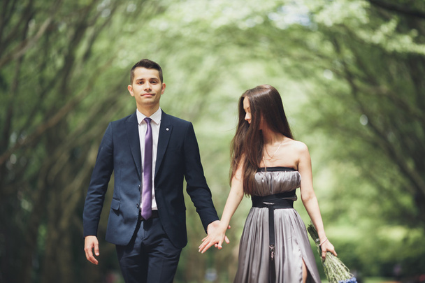 Handsome young couple posing outdoors after ceremony - Photo, image